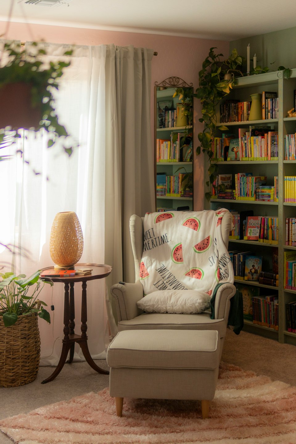Cozy reading nook with armchair, blanket, and bookcase.